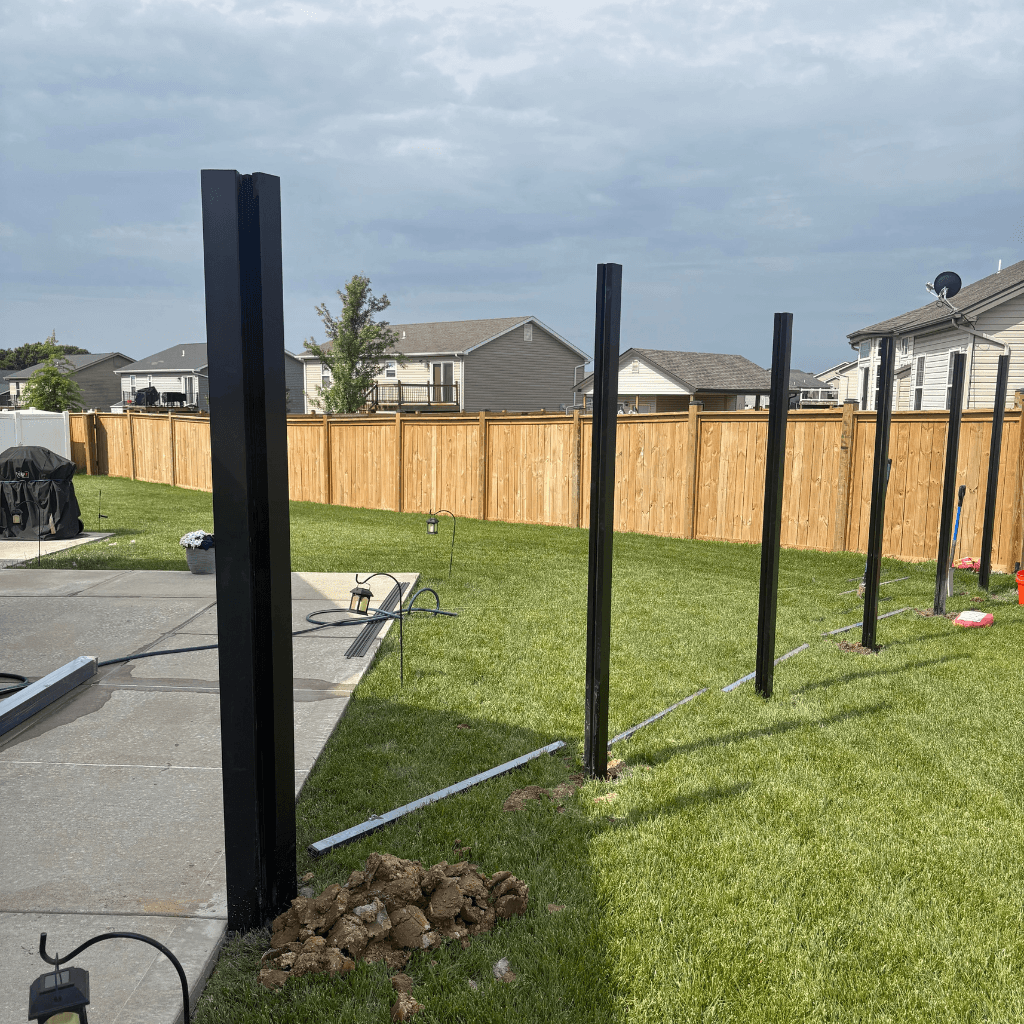 The aluminum posts for a composite fence being installed