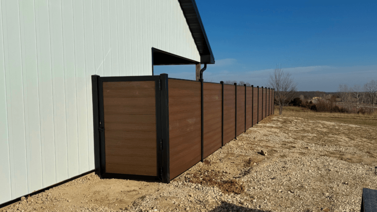 Brown composite fence with a 4ft gate.