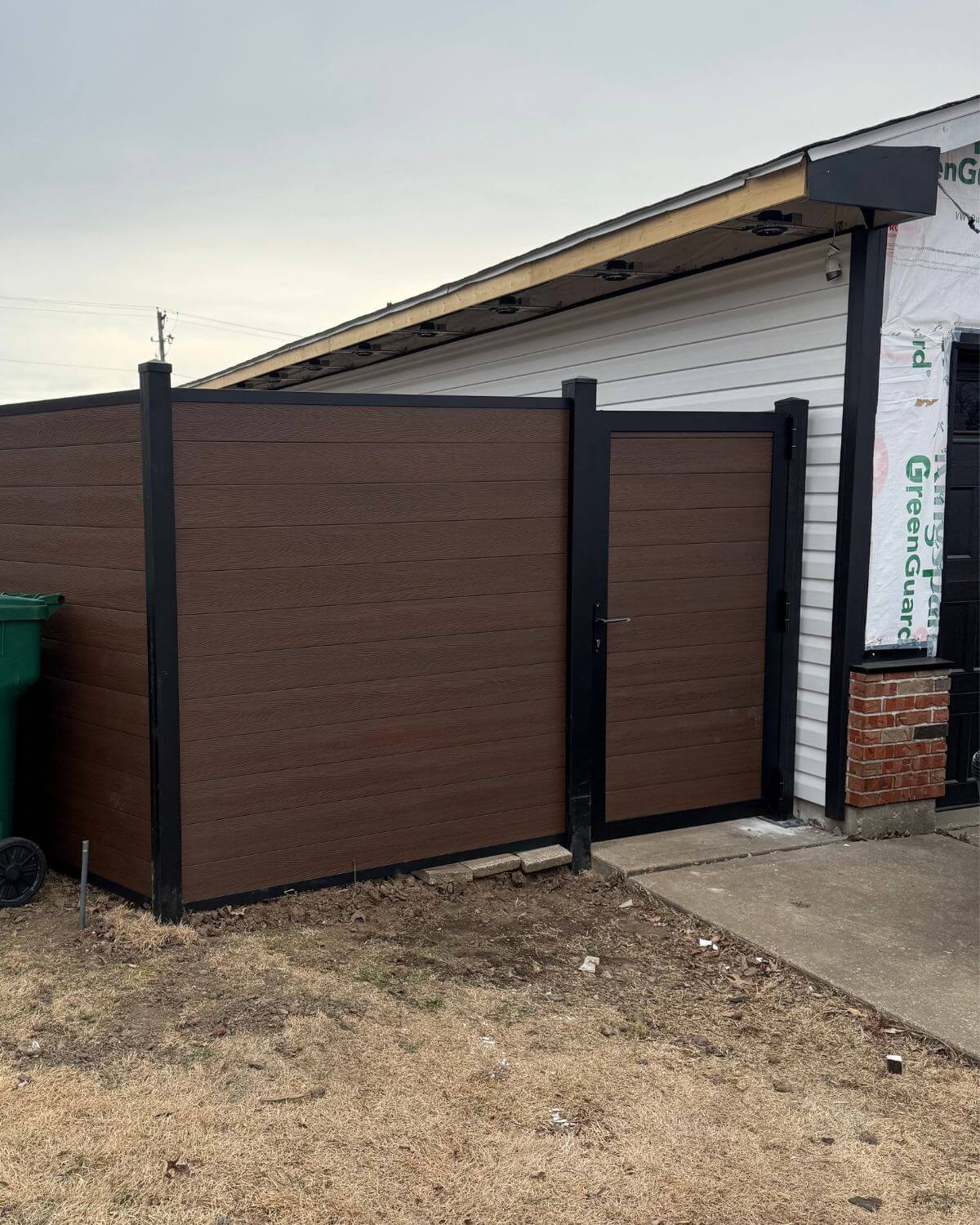Installed full privacy 6ft Brown composite fence showing tight horizontal boards